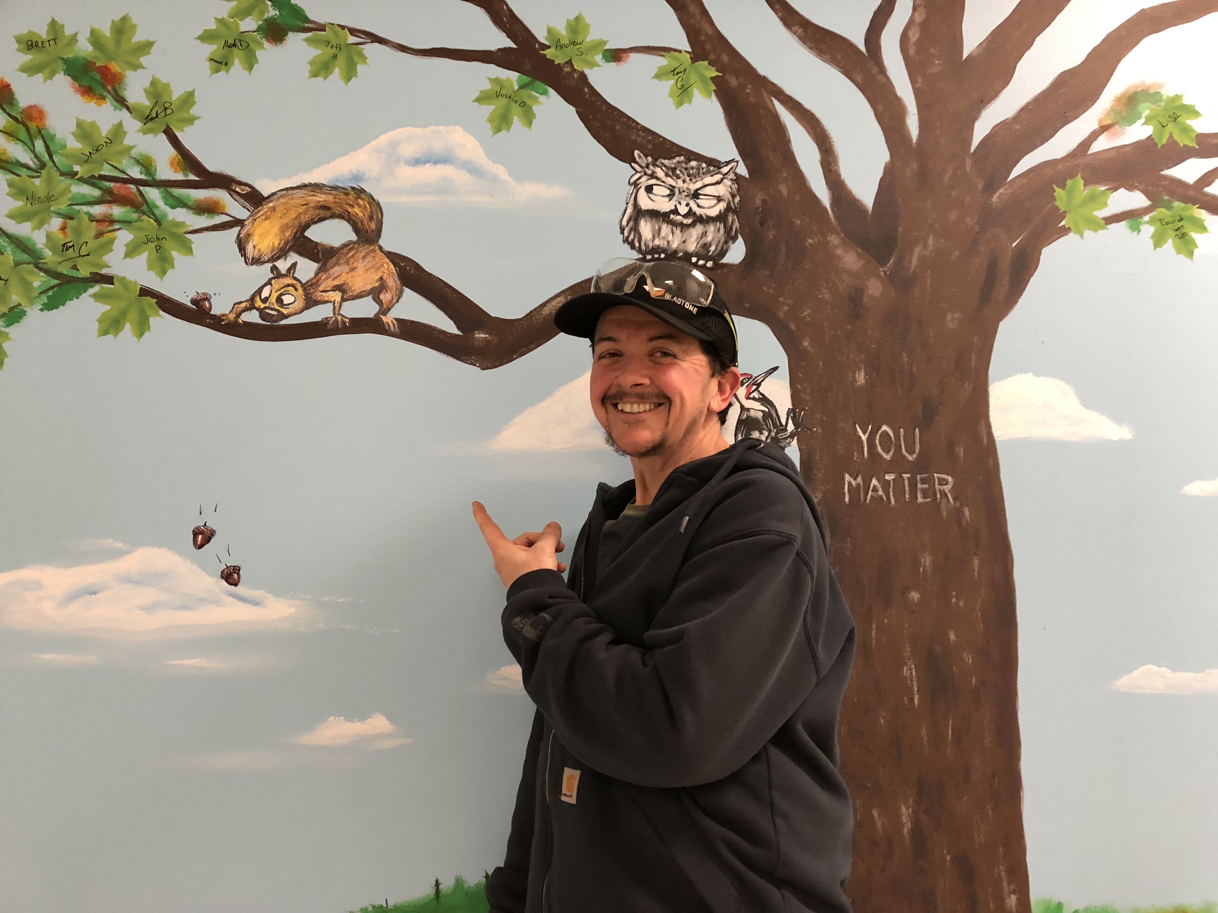 Jody Veilleux paints CBI diversity, equity, and inclusion mural.